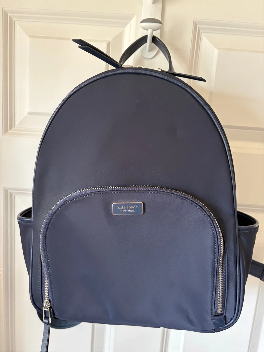 kate spade navy backpack with front zip pocket